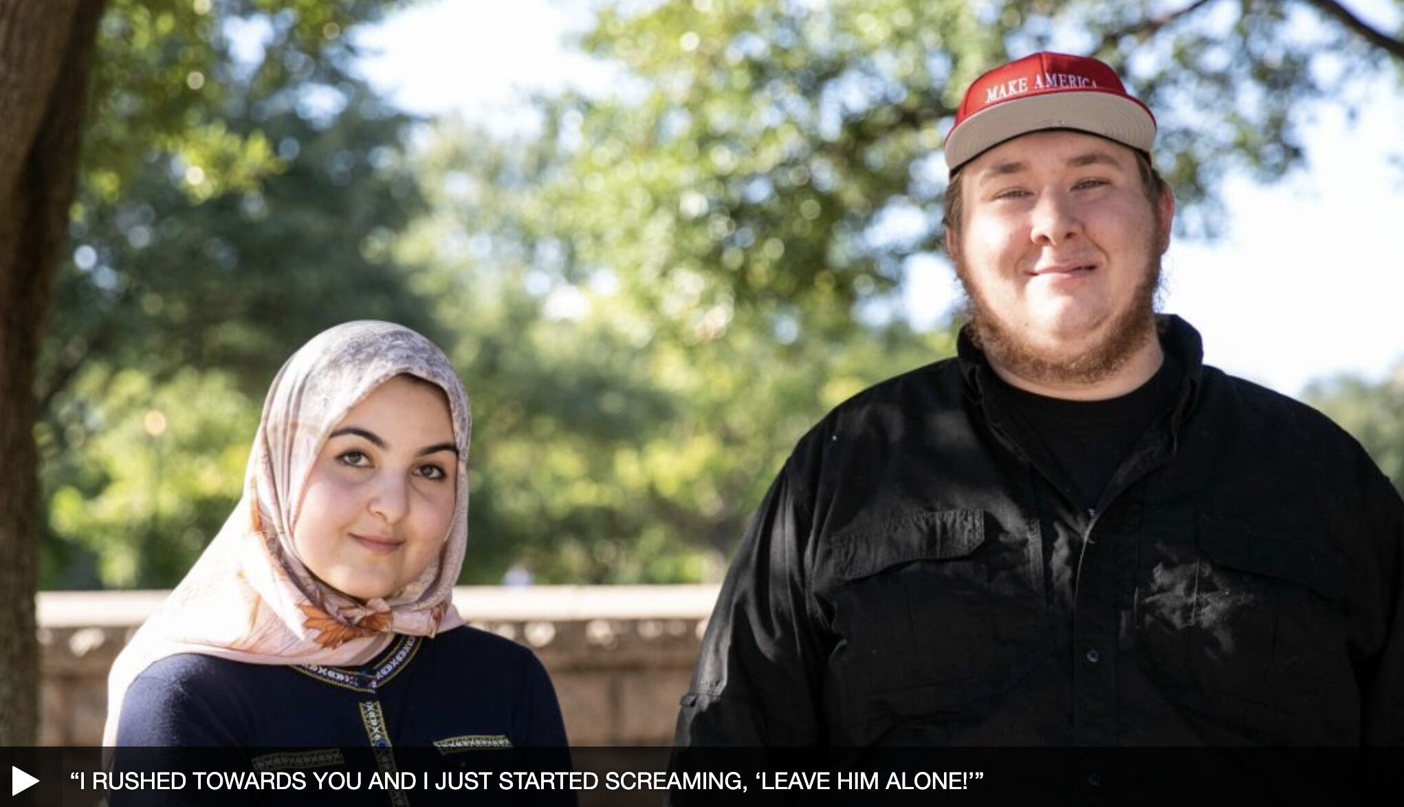 A female wearing a hijab next to a male wearing a MAGA hat.